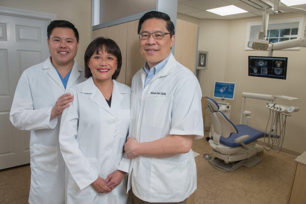 Dr. Jeffrey Pan, Dr. Debra Pan, and Dr. Nelson Pan standing together in dental office Pan Dental Care, Endodontists Melrose MA