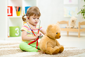 child playing with a teddy bear