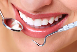 dental tools near mouth with beautiful white and straight teeth, South Riding, VA cosmetic dentistry Fairfax, VA