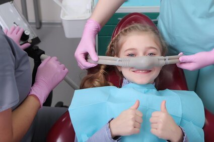 young girl at dentist wearing nitrous oxide mask, dentist Asheville, NC family dentistry