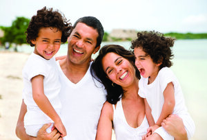 family at beach all smiling and happy West Bloomfield, MI general dentistry