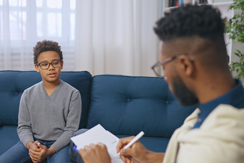 Pediatrician evaluates a child's behavior and development during a clinical assessment.