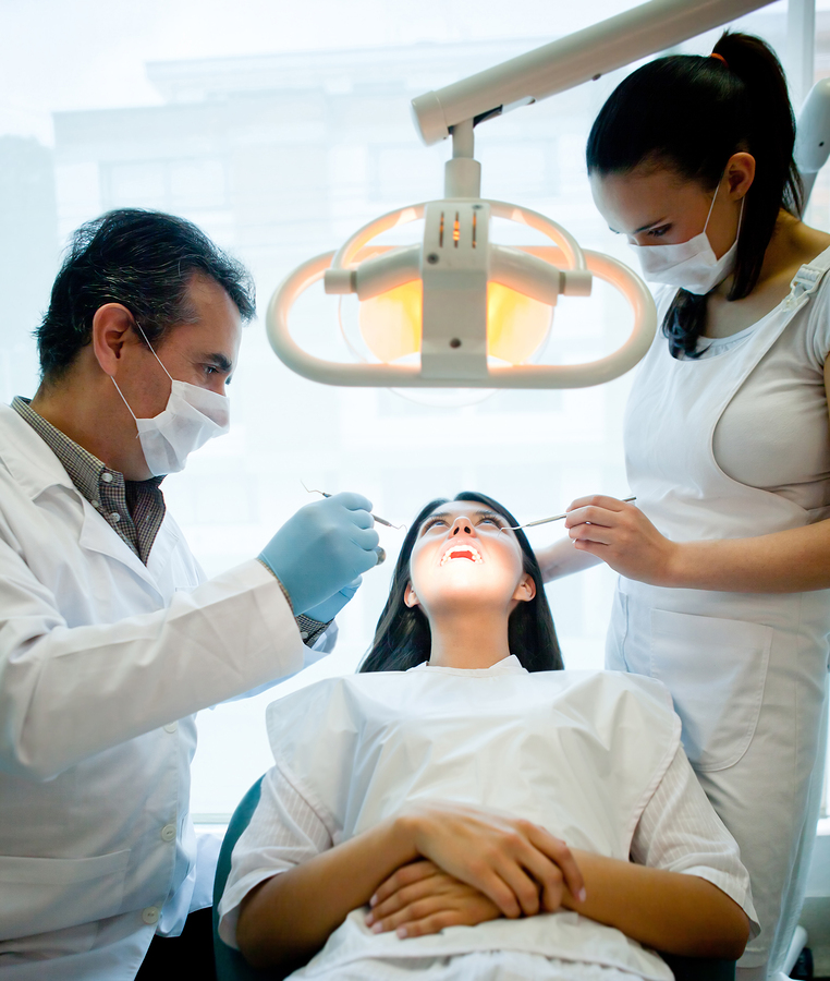 girl in dental exam room being examined by emergency dentist Arlington, TX