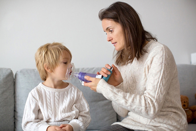 Young boy suffering from Asthma with her mother