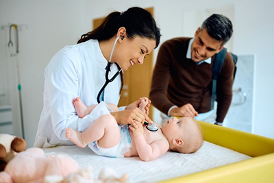 Newborn wellness check with father and pediatrician