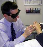Dr. Dr Khanh Le performing laser therapy