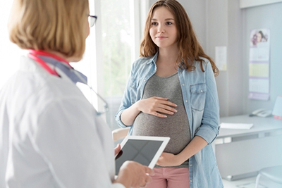 Pregnant woman consulting pediatrician for prenatal care