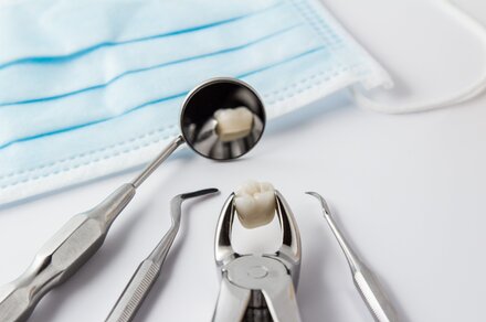 assortment of dental tools and crown on countertop, dentist Lawrenceville, GA general dentistry