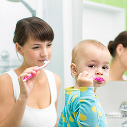Mom and child brushing their teeth