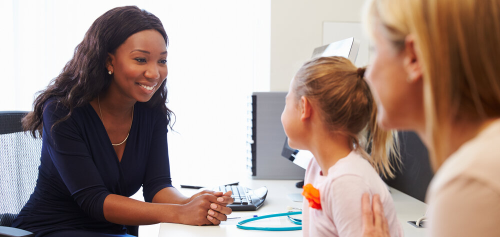 Woman provider before test with child patient